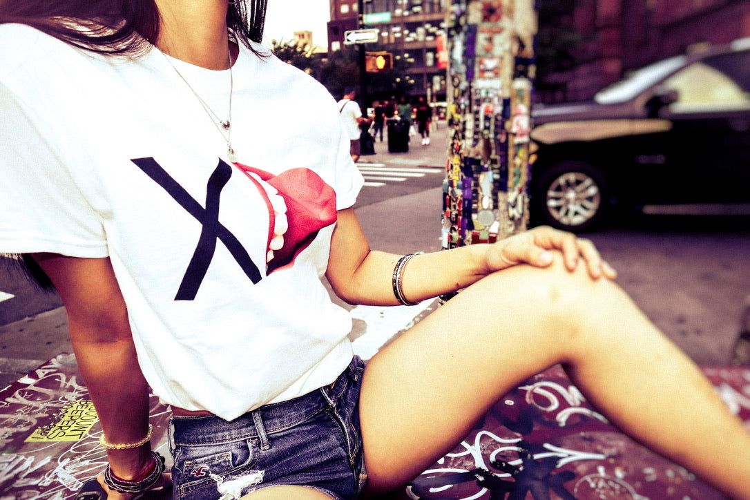 Person sitting on a street with a cityscape background